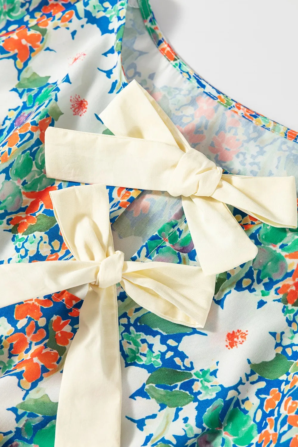 Floral Print Bow Applique Slit Sleeveless Peplum Blouse - Concordia Style Boutique