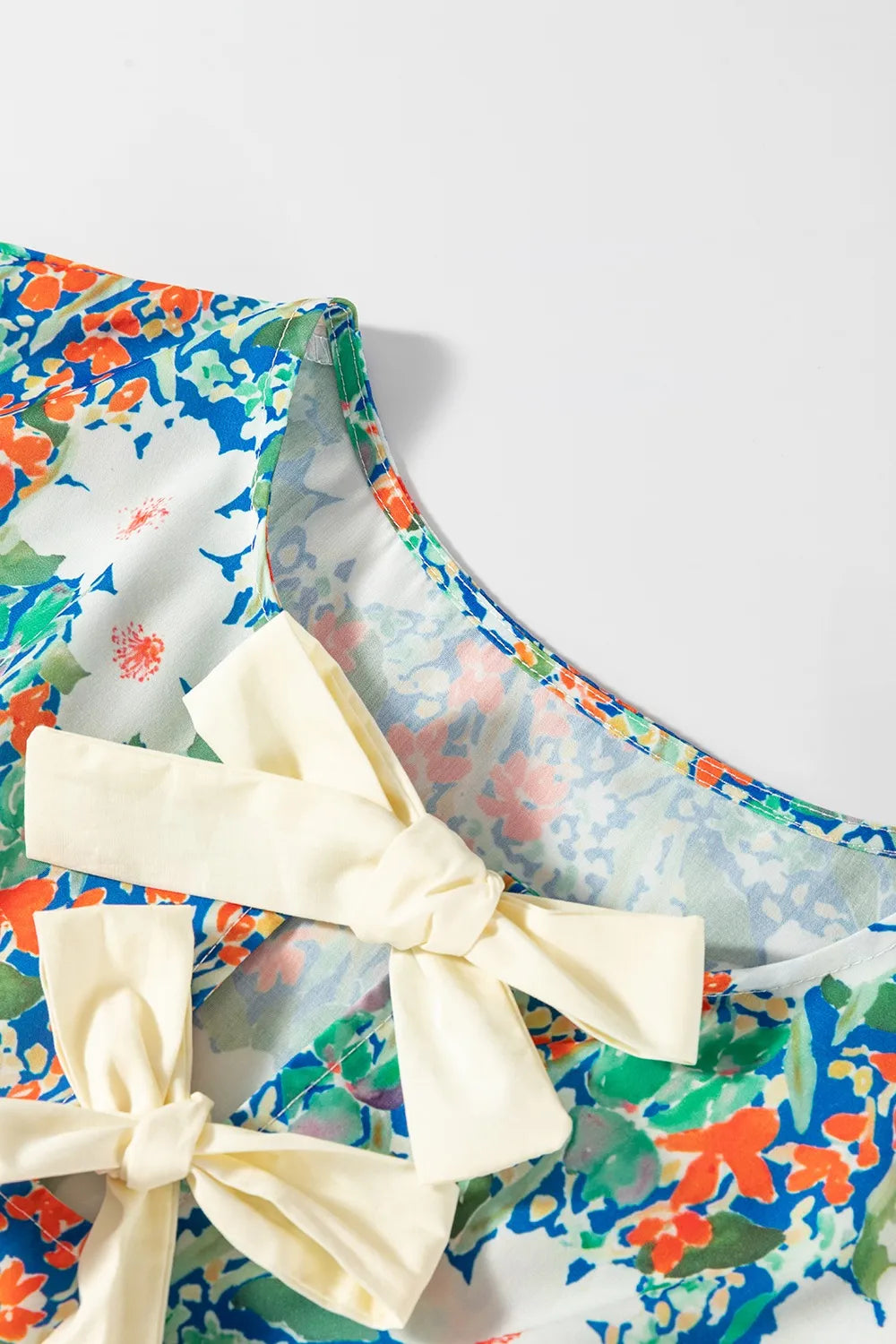 Floral Print Bow Applique Slit Sleeveless Peplum Blouse - Concordia Style Boutique